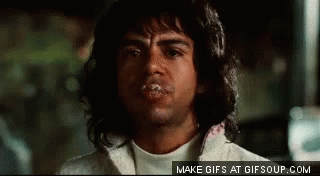 A Man With Long Hair Is Making A Funny Face With His Mouth Covered In Saliva . GIF