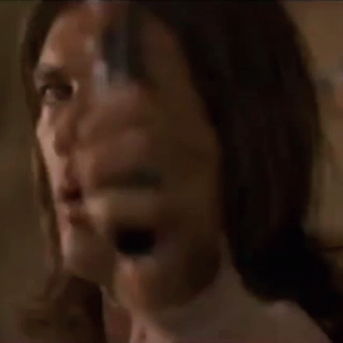 A Man With Long Hair Is Pointing A Gun At Someone GIF