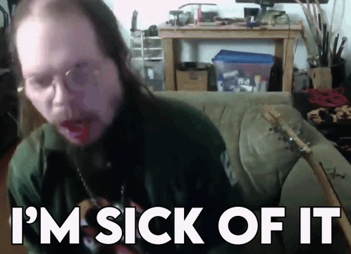 A Man With Long Hair Is Sitting On A Couch With The Words I 'M Sick Of It Behind Him GIF