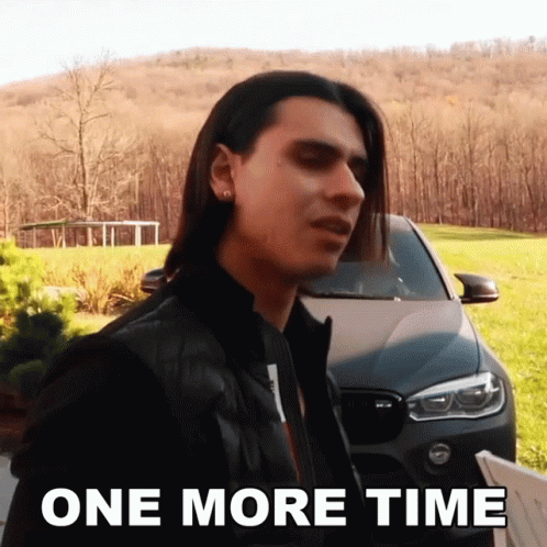 A Man With Long Hair Is Standing In Front Of A Car With The Words One More Time Below Him GIF