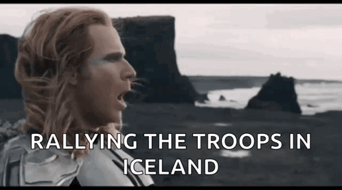 A Man With Long Hair Is Standing In Front Of A Rocky Cliff And The Words Rallying The Troops In Iceland GIF