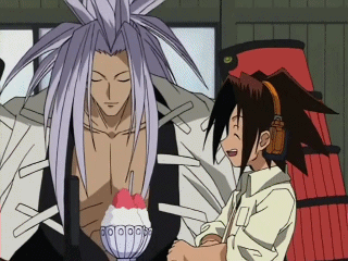 A Man With Long Hair Is Standing Next To Another Man GIF