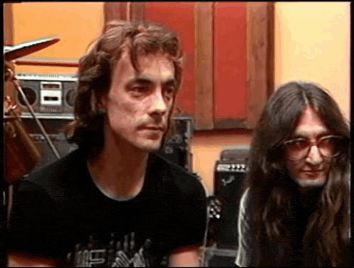 A Man With Long Hair Is Wearing A Black Shirt That Says ' I Love You ' On The Front GIF