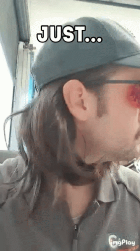 A Man With Long Hair Is Wearing A Hat And Sunglasses And Says Just ... GIF