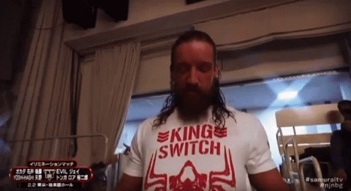 a man with long hair is wearing a king switch t-shirt
