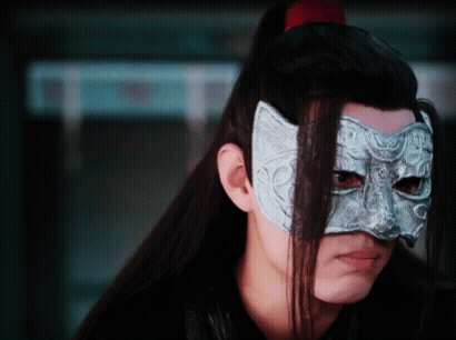 A Man With Long Hair Is Wearing A Mask On His Face . GIF