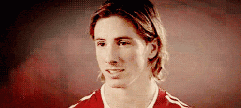 A Man With Long Hair Is Wearing A Red And White Shirt GIF
