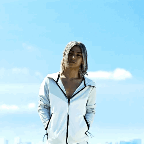 A Man With Long Hair Is Wearing A White Hoodie GIF
