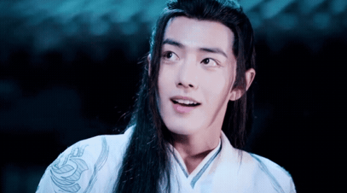 A Man With Long Hair Is Wearing A White Shirt With A Dragon On It GIF