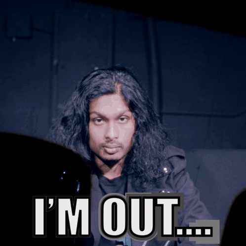 A Man With Long Hair Says I 'M Out In Front Of A Dark Background GIF