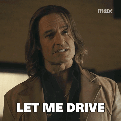 A Man With Long Hair Says Let Me Drive In Front Of A Max Logo GIF