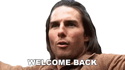 a man with long hair says welcome back on a white background