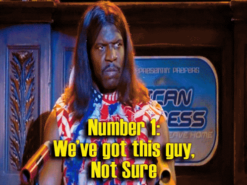 A Man With Long Hair Stands In Front Of A Sign That Says Fan Mess GIF