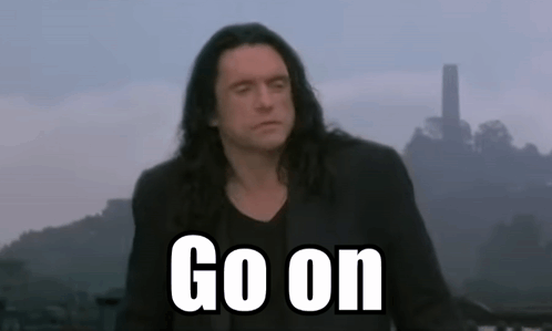 A Man With Long Hair Stands In Front Of A Sign That Says " Go On " GIF