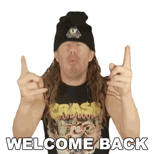 a man with long hair wearing a crash bandicoot shirt