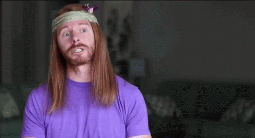 A Man With Long Hair Wearing A Headband And A Purple Shirt Says Stay Focused GIF