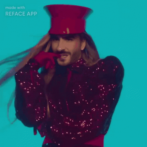 A Man With Long Hair Wearing A Red Top Hat And Sequined Jacket Made With Reface App GIF