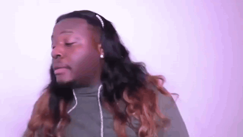 A Man With Long Hair Wearing Headphones And A Headband . GIF