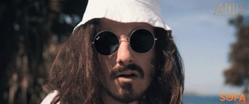 A Man With Long Hair Wearing Sunglasses And A White Hat With The Word Janik On The Bottom GIF