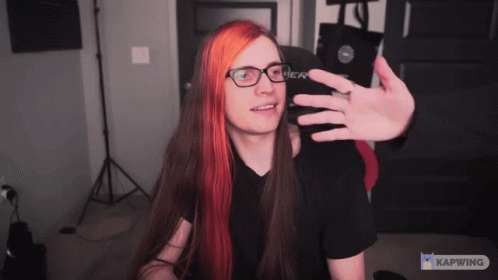 A Man With Long Red Hair And Glasses Takes A Selfie With Kapwing GIF