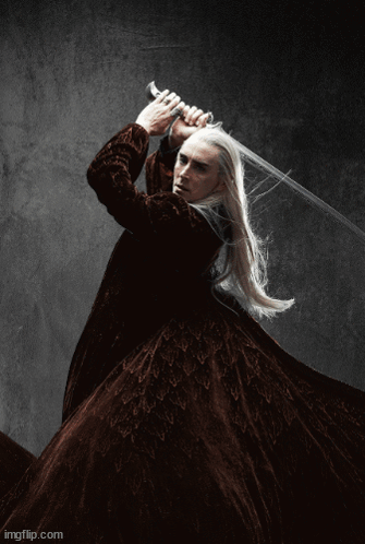 A Man With Long White Hair Is Holding A Large Sword In His Hand . GIF