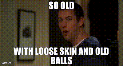 A Man With Loose Skin And Old Balls Is Standing In A Hallway GIF