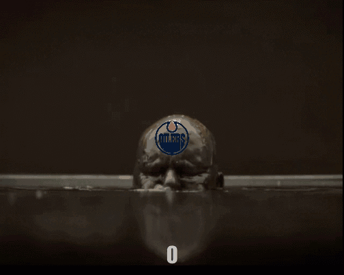 A Man With Oilers On His Head Is In A Bathtub GIF