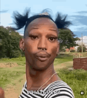 A Man With Pigtails And A Nose Ring Is Standing In A Field And Making A Funny Face . GIF