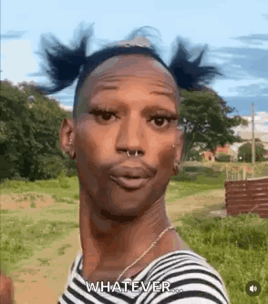 A Man With Pigtails On His Head And A Nose Ring Is Standing In A Field . GIF