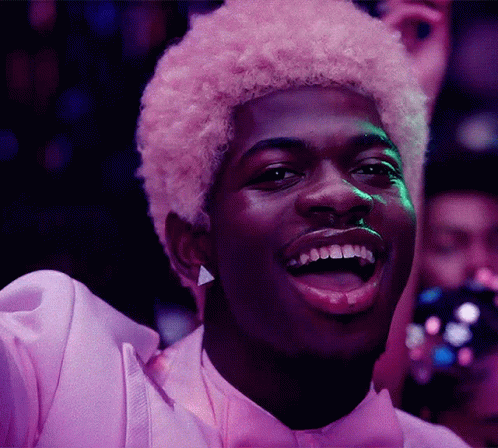 A Man With Pink Hair Is Wearing A Purple Shirt And Bow Tie GIF