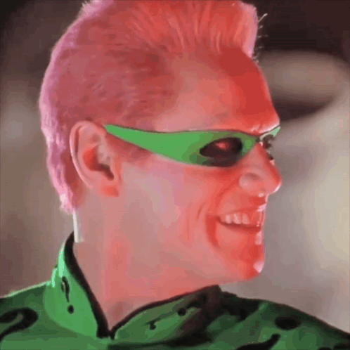 A Man With Pink Hair Wearing Green Sunglasses And A Green Shirt GIF