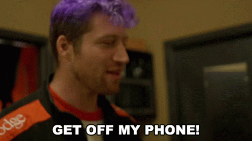 A Man With Purple Hair And A Jacket That Says Dodge On It GIF