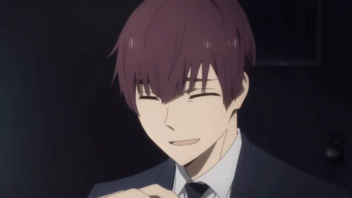 A Man With Purple Hair And A Suit Is Smiling With His Eyes Closed GIF