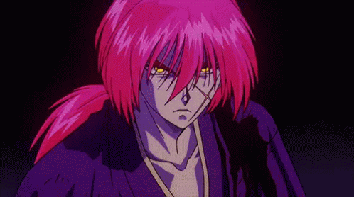 A Man With Purple Hair And Yellow Eyes Is Standing In The Dark . GIF