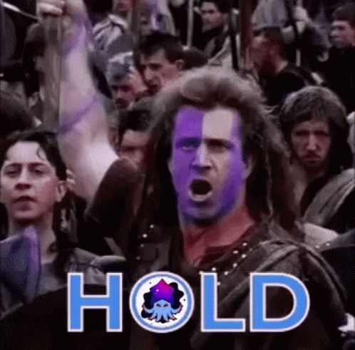 A Man With Purple Paint On His Face Is Standing In Front Of A Crowd With The Word Hold Written On The Bottom . GIF