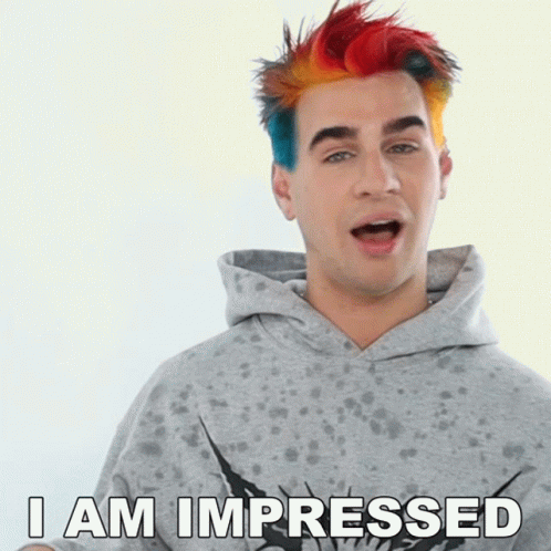 A Man With Rainbow Hair Says " I Am Impressed " GIF