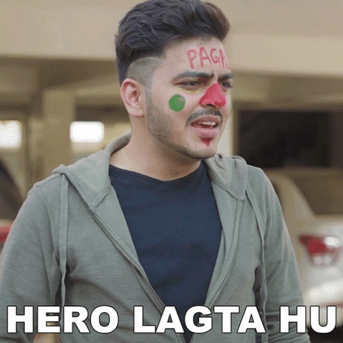 A Man With Red And Green Paint On His Face Has The Words Hero Lagta Hu Written Below Him GIF