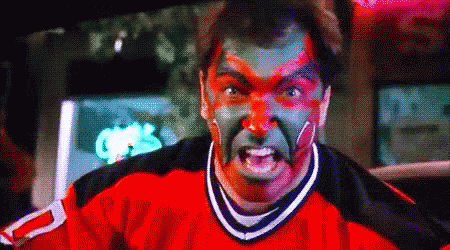 A Man With Red And Green Paint On His Face Is Wearing A Jersey With The Number 2 On It . GIF