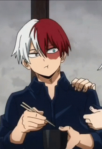 A Man With Red And White Hair Is Holding Chopsticks And Making A Face GIF