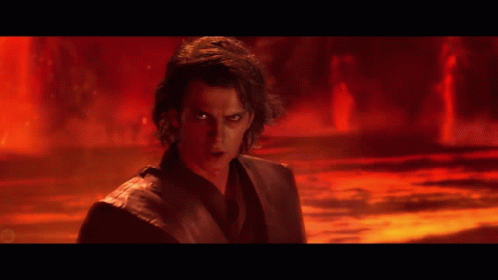 A Man With Red Eyes Is Standing In A Dark Room GIF