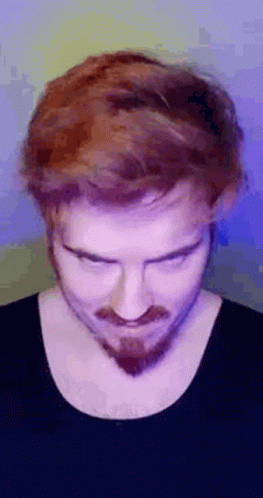 A Man With Red Hair And A Beard Is Making A Funny Face With His Eyes Closed . GIF