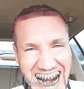 A Man With Red Hair And A Beard Is Sitting In A Car With His Mouth Open . GIF