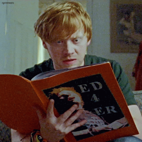 A Man With Red Hair Is Reading A Book Titled Ed 4 Er GIF