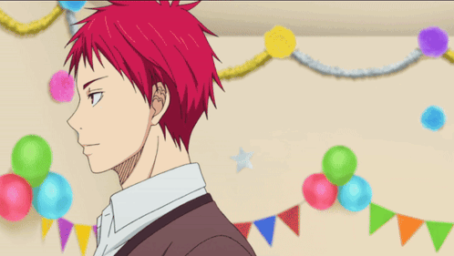 A Man With Red Hair Is Smiling In Front Of Balloons And Flags GIF