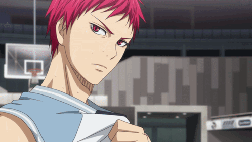 A Man With Red Hair Is Standing In Front Of A Basketball Court GIF