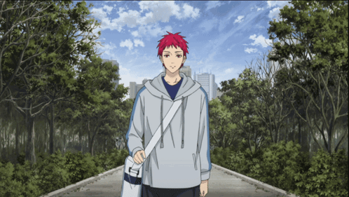 A Man With Red Hair Is Walking Down A Path In A Park GIF
