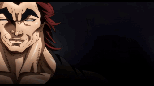 A Man With Red Hair Is Waving His Hand In A Dark Room GIF