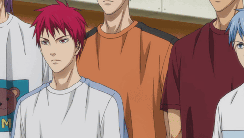 A Man With Red Hair Is Wearing A White Shirt With The Letter M On It GIF