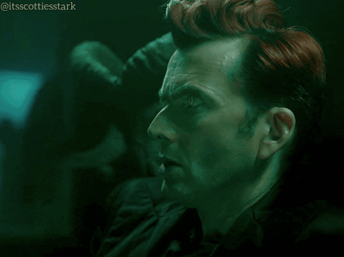 A Man With Red Hair Says Ooh How Mysterious In A Dark Room GIF