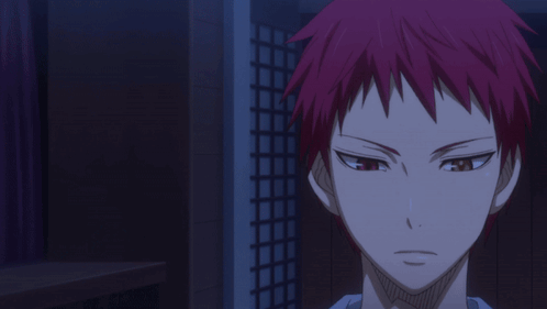 A Man With Red Hair Stands In A Dark Room With Another Man Holding A Basketball GIF